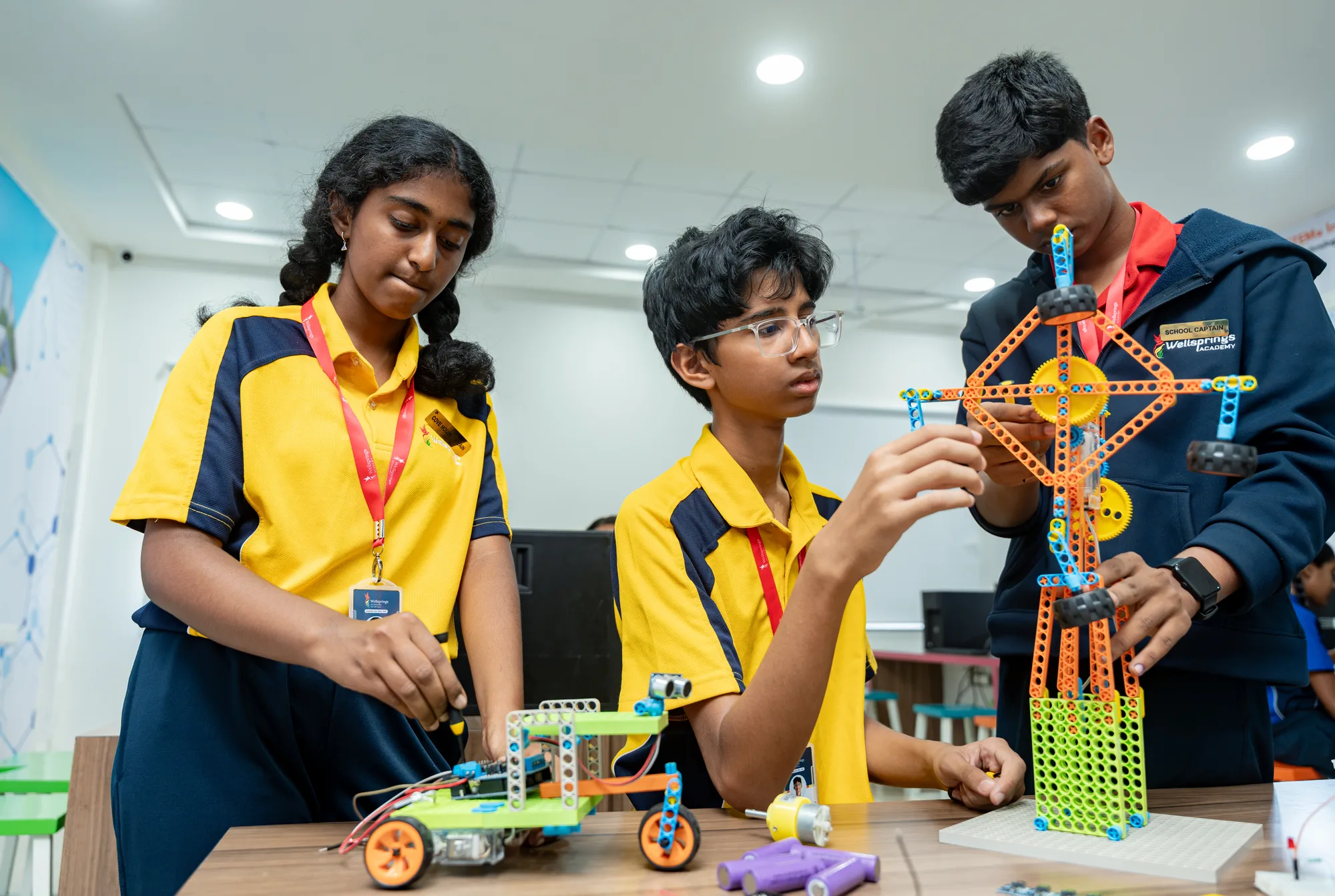 Wellsprings students building a tall model with construction pieces